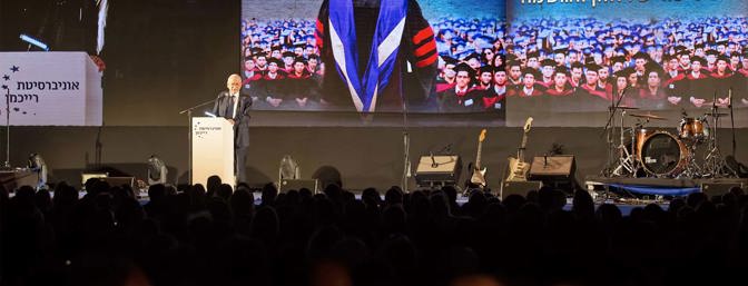 Professor Reichman Speaking on stage