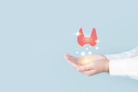 A hand holding a glowing, translucent, pink and white anatomical heart shape against a blue background.
AI-generated content may be incorrect.