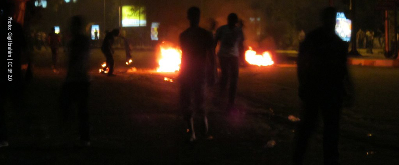Shadowed characters with fires on the background
