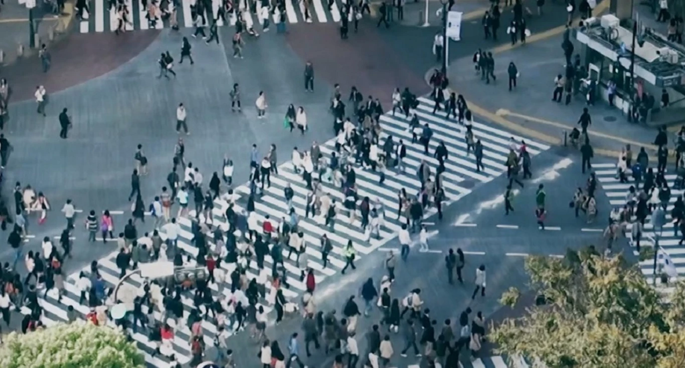 Picture of people crossing a large crosswalk